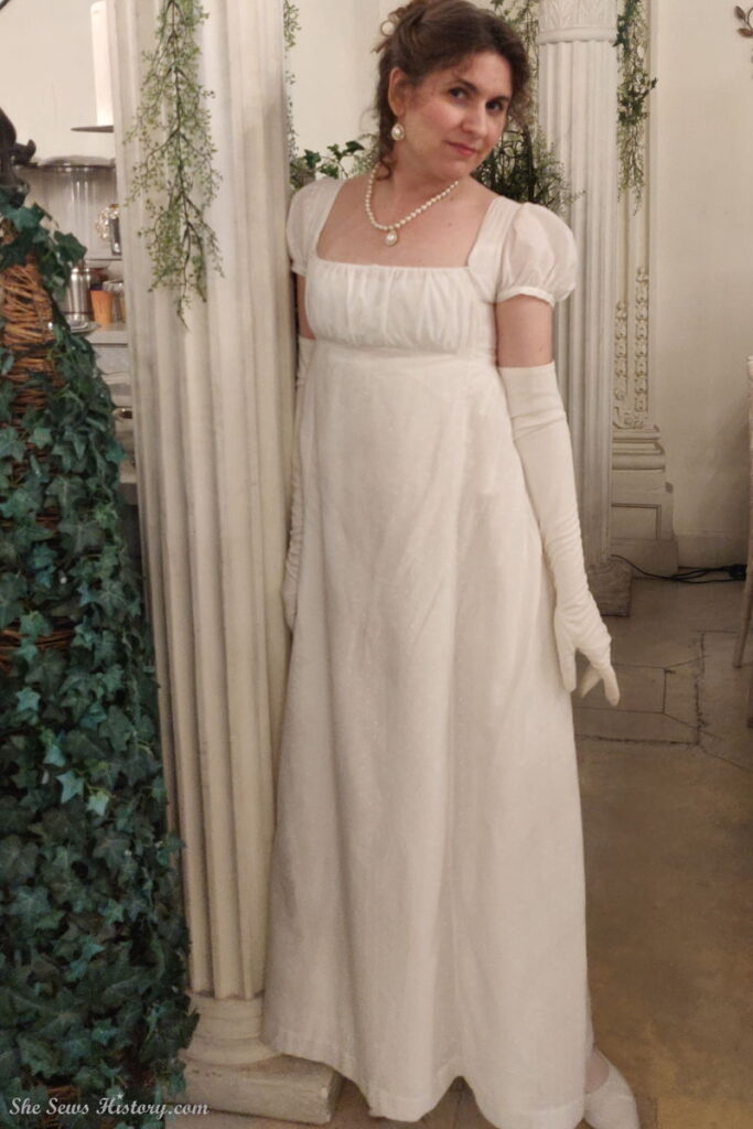 White Regency Gown next to Grecian Architecture