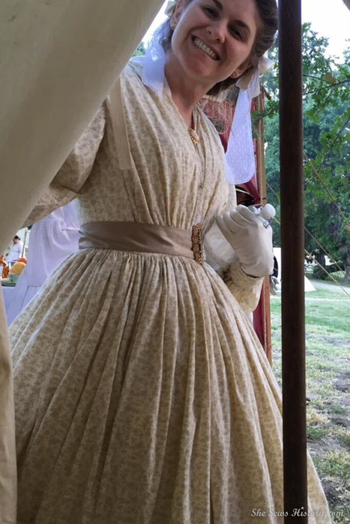 Girl in 1860's Cotton Dress peeking in tent at Civil War Reenactment