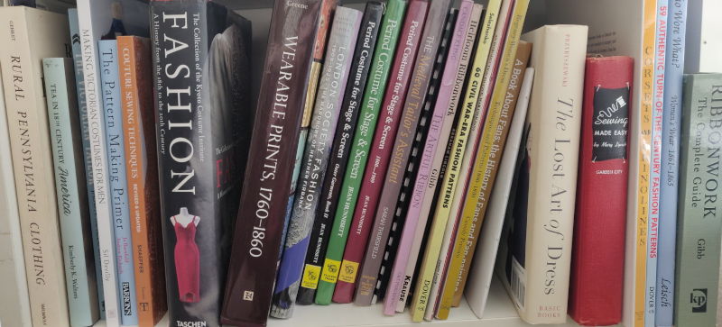 A row of Historical Costuming Books on a shelf